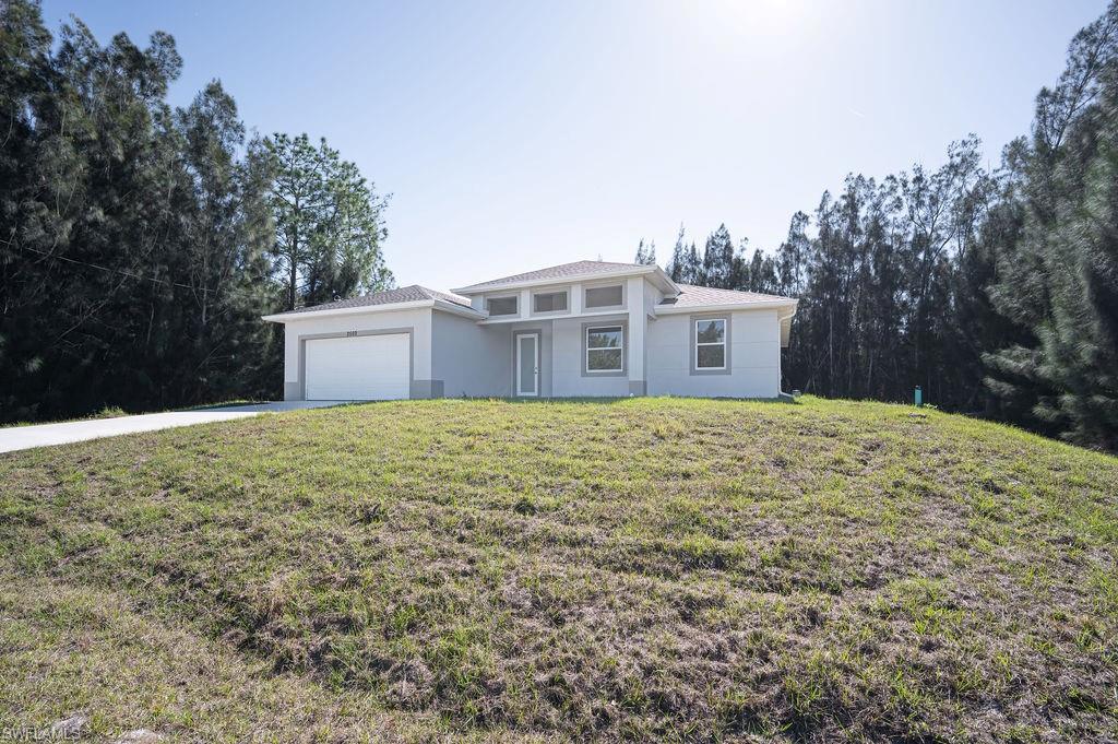 241 Novia Lehigh Acres, FL 33974 - Photo 26 of 28 a front view of a house with a yard