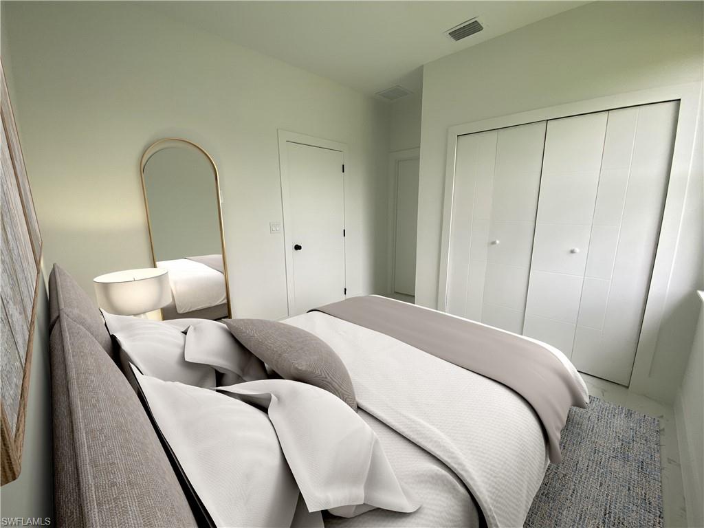 241 Novia Lehigh Acres, FL 33974 - Photo 4 of 28 a bed room with a bed and a mirror