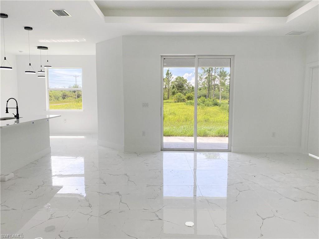 241 Novia Lehigh Acres, FL 33974 - Photo 10 of 28 a view of a kitchen with a sink and a dishwasher next to a window