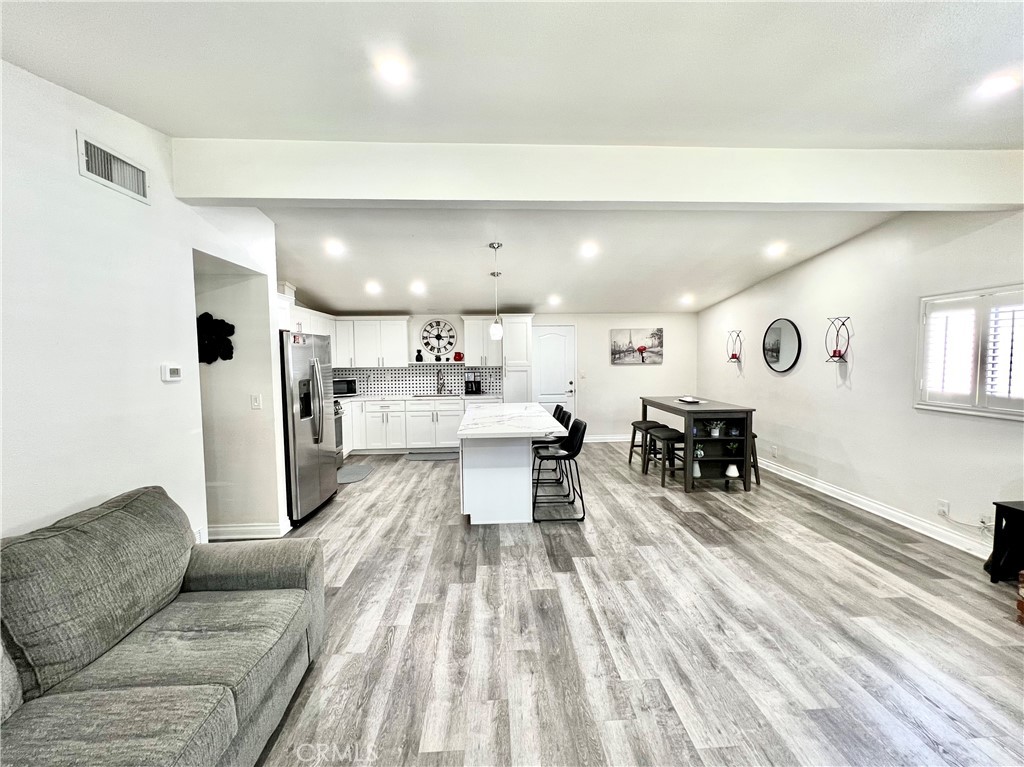 11561 Cherrylee Drive El Monte, CA 91732 - Photo 3 of 8 a living room with furniture and a dining table with kitchen view