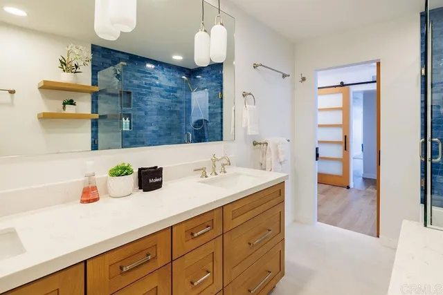 a bathroom with a sink double vanity and a shower