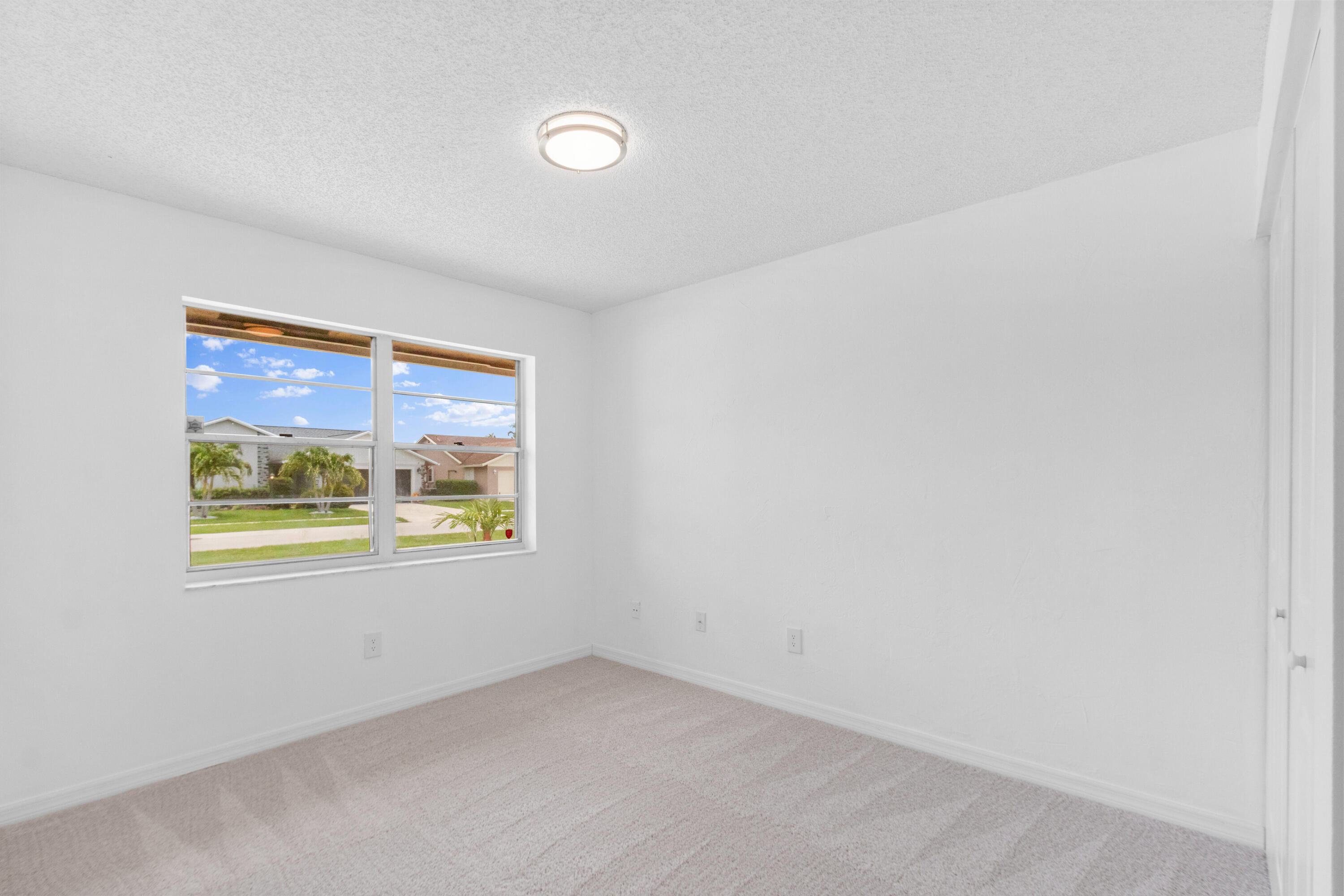 23089 Southwest 55th Avenue Boca Raton, FL 33433 - Photo 13 of 29 an empty room with a window
