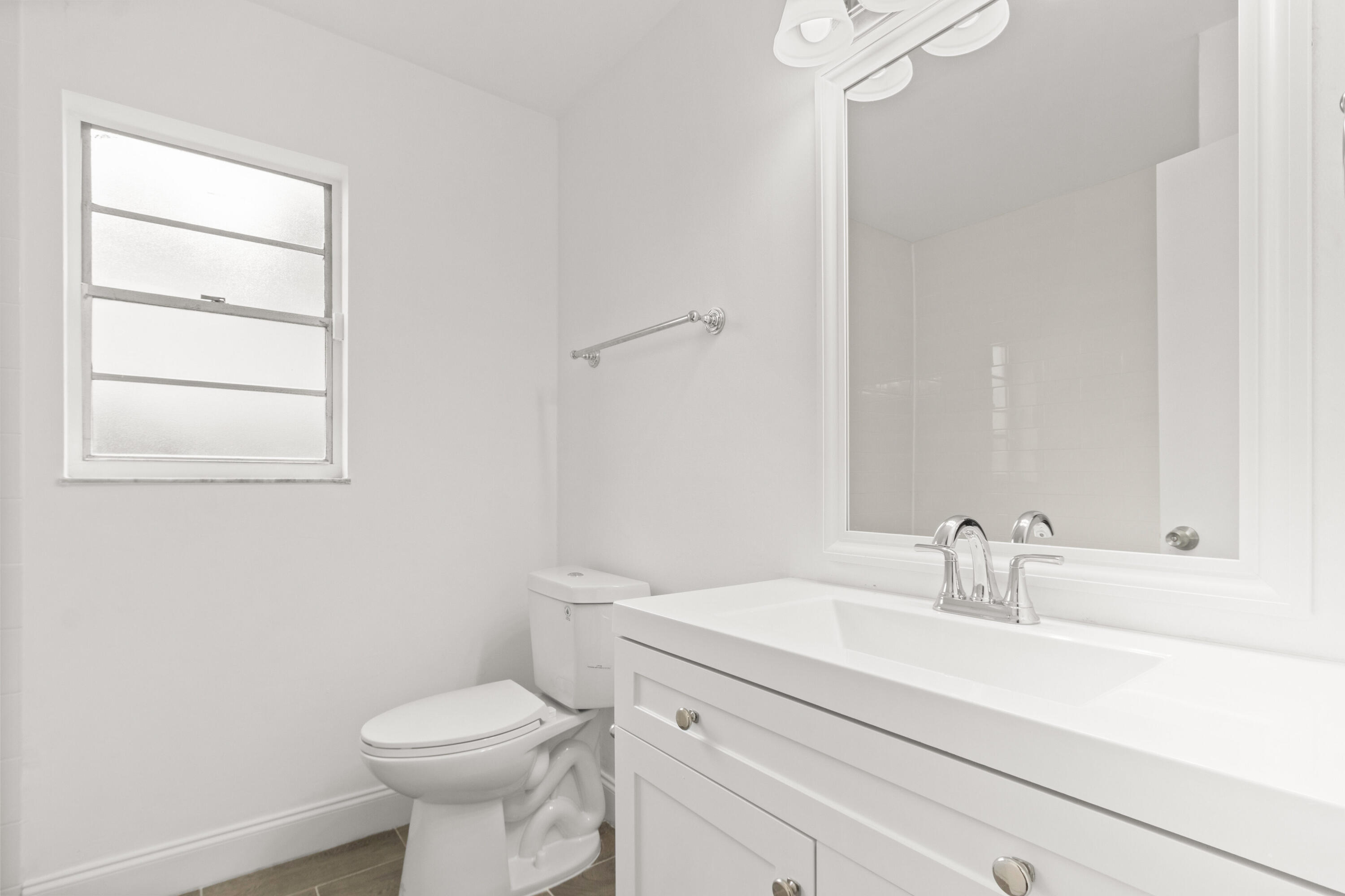 23089 Southwest 55th Avenue Boca Raton, FL 33433 - Photo 15 of 29 a bathroom with a sink toilet and a mirror