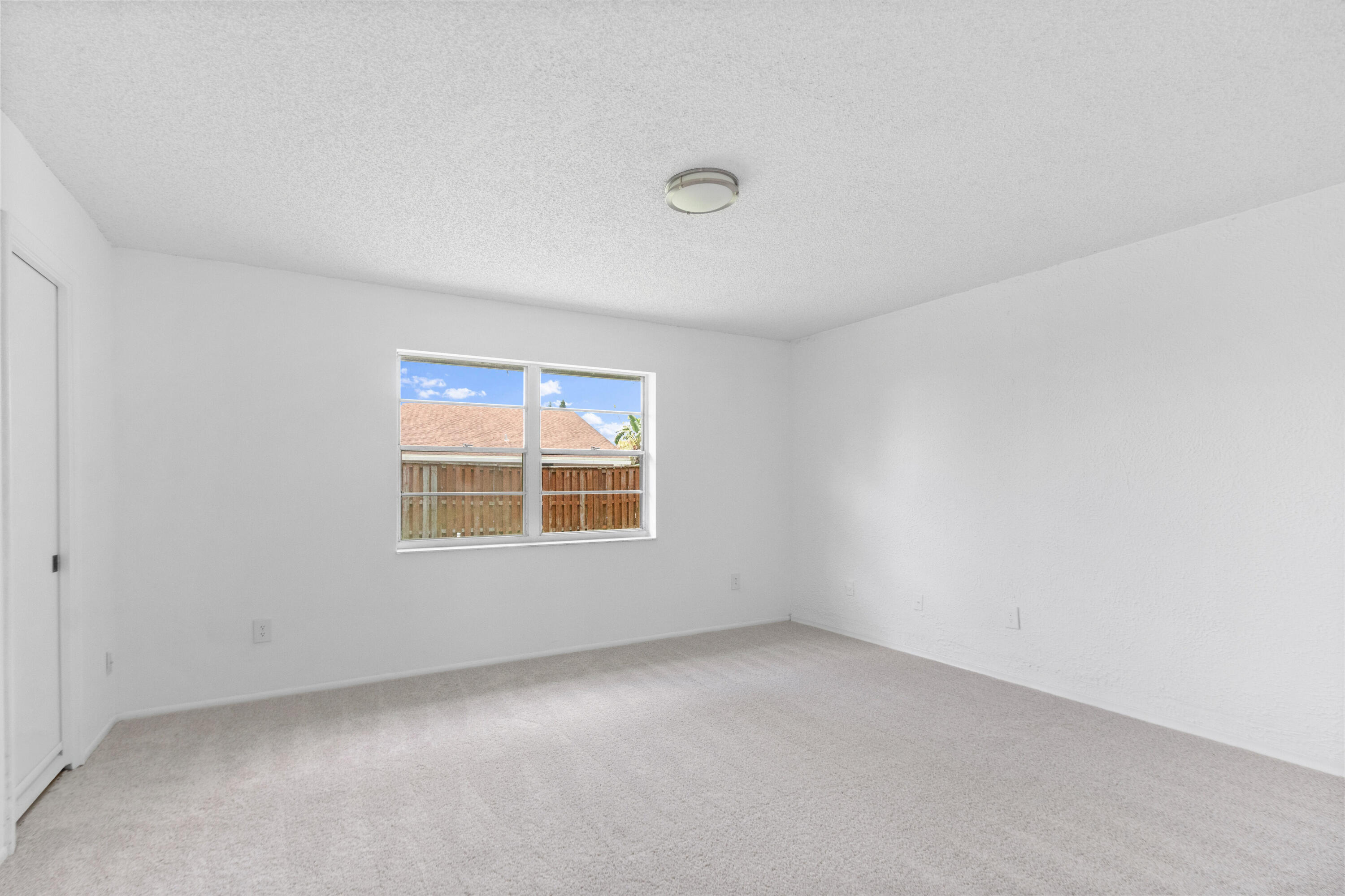 23089 Southwest 55th Avenue Boca Raton, FL 33433 - Photo 16 of 29 an empty room with a window