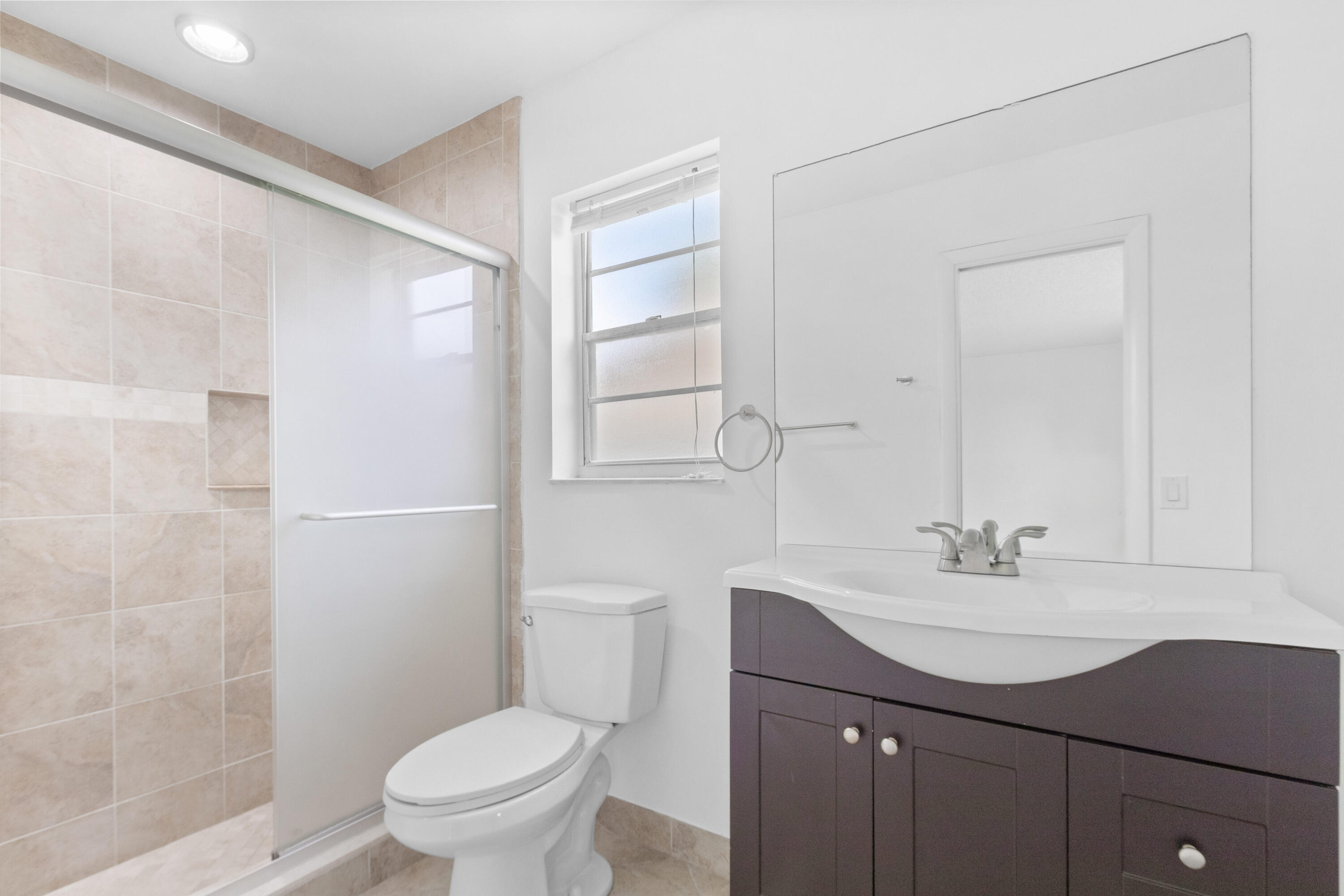 23089 Southwest 55th Avenue Boca Raton, FL 33433 - Photo 18 of 29 a bathroom with a sink a toilet and shower