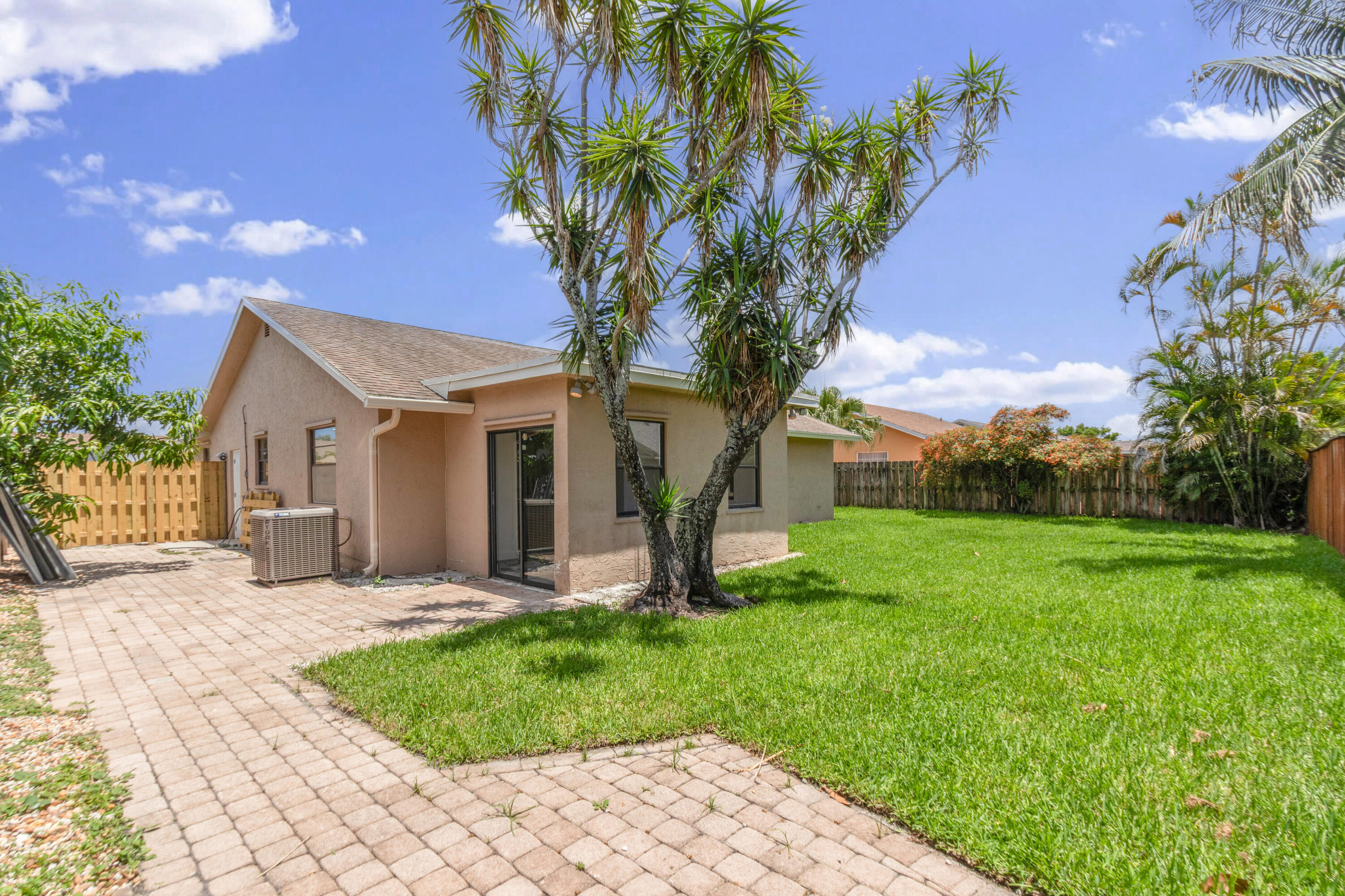 23089 Southwest 55th Avenue Boca Raton, FL 33433 - Photo 20 of 29 a front view of a house with garden