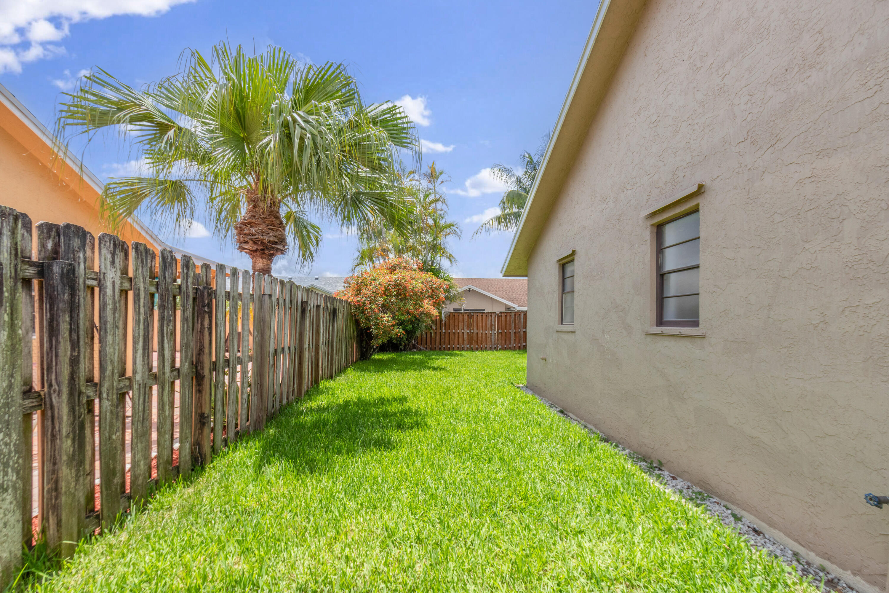 23089 Southwest 55th Avenue Boca Raton, FL 33433 - Photo 23 of 29 a view of a backyard with potted plants
