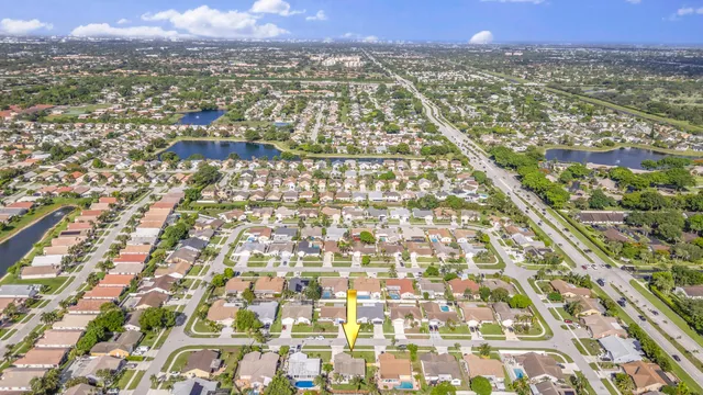 an aerial view of residential houses with outdoor space and parking