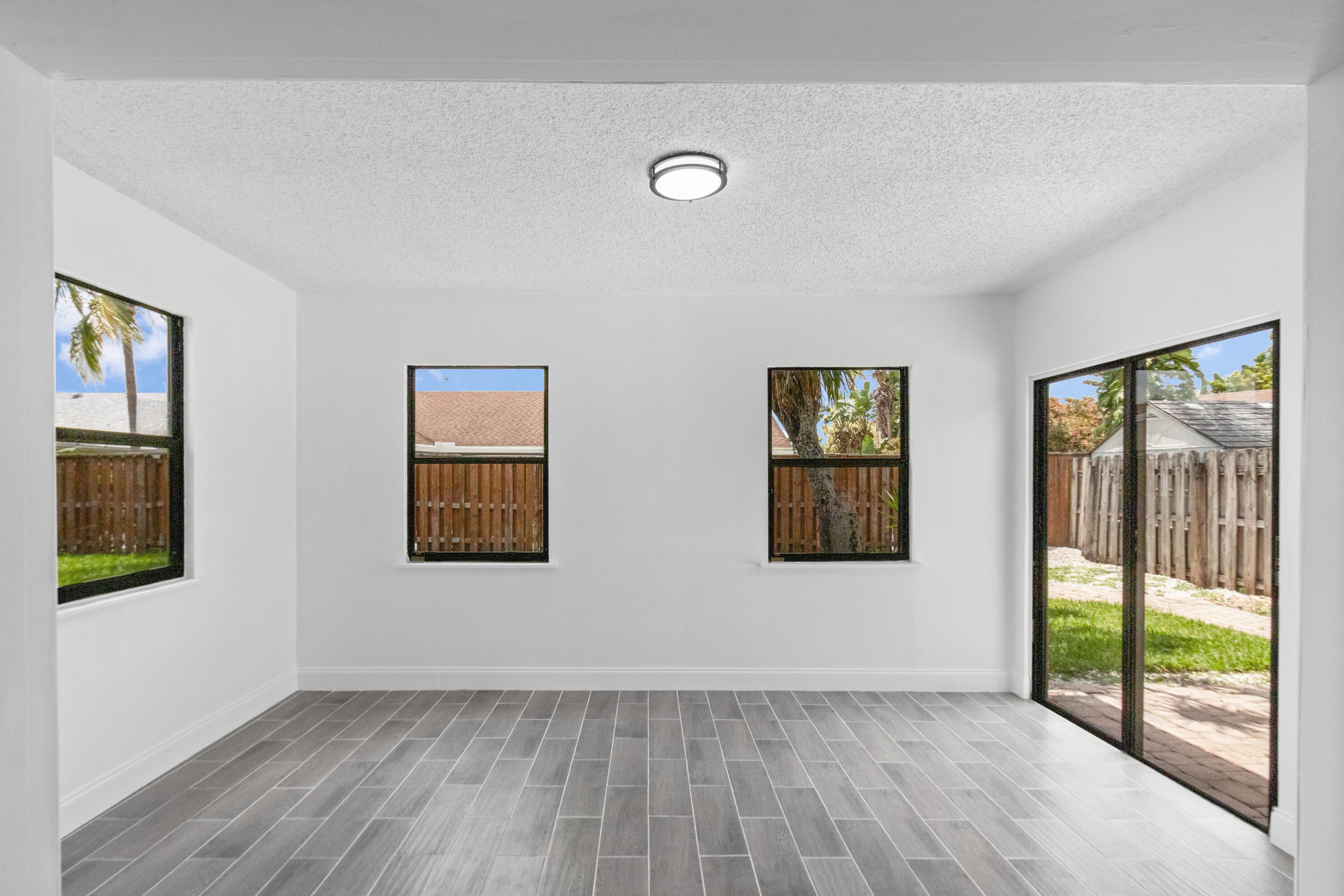 23089 Southwest 55th Avenue Boca Raton, FL 33433 - Photo 7 of 29 a view of an empty room with glass door and balcony