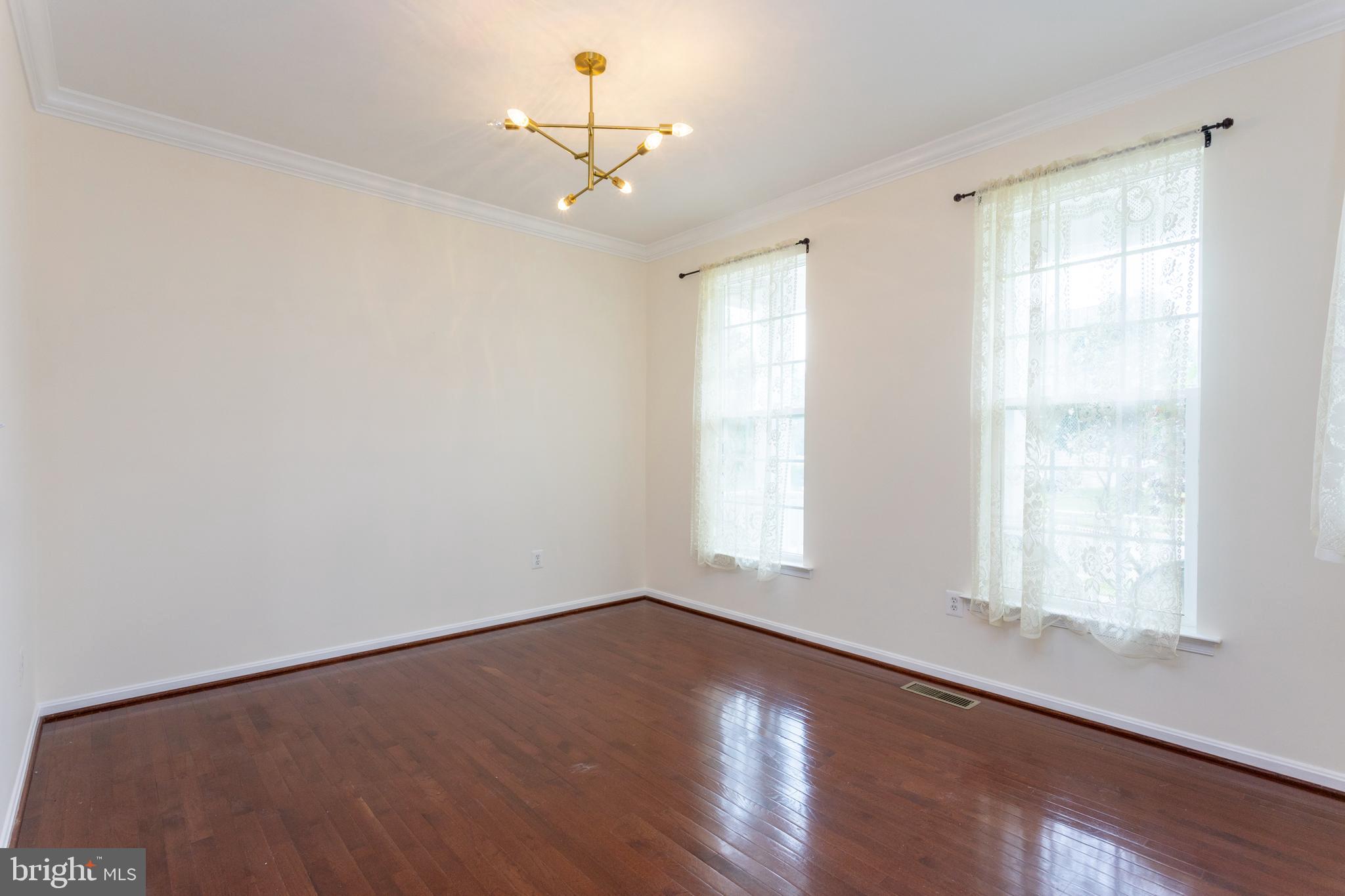 2007 Thistlewood Road Baltimore, MD 21209 - Photo 10 of 69 wooden floor in an empty room with a window