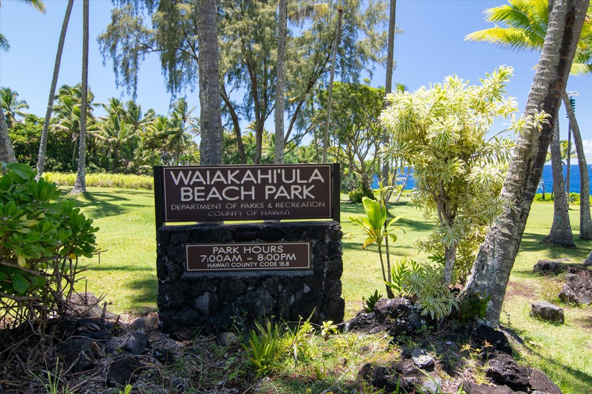 15-2761 Opihi Street Pahoa, HI 96778 - Photo 12 of 27 a sign that is sitting in front of flowers