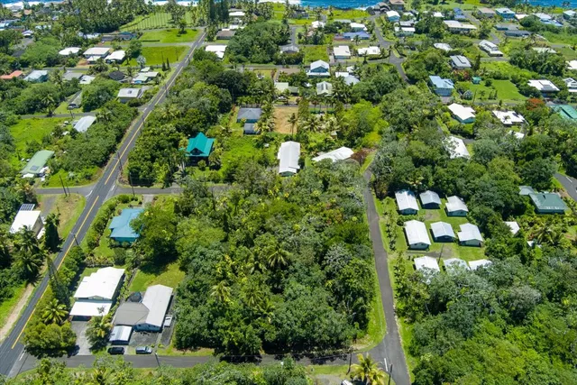 an aerial view of a house with a yard