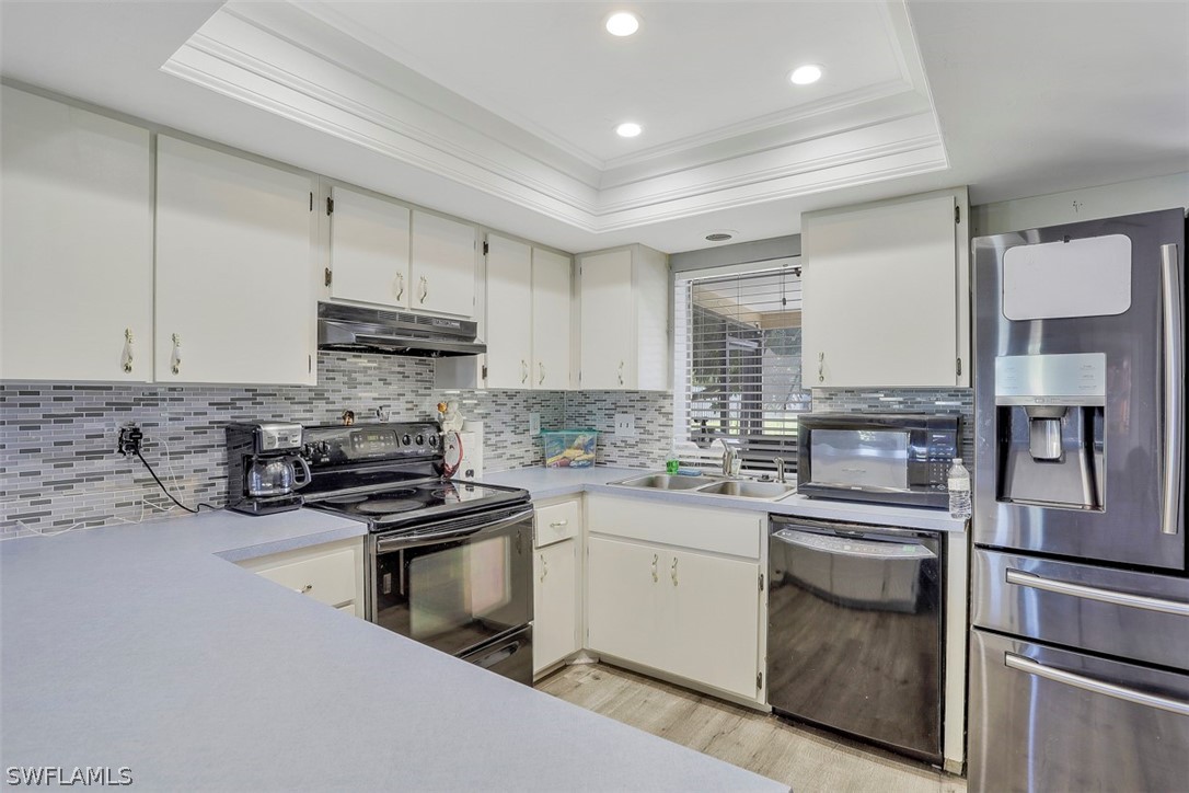 a kitchen with stainless steel appliances granite countertop a sink stove oven and refrigerator