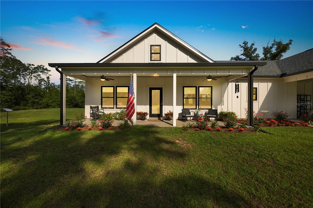 5149 Southwest 119th Road Lake Butler, FL 32054 - Photo 37 of 40 a front view of a house with a garden and patio