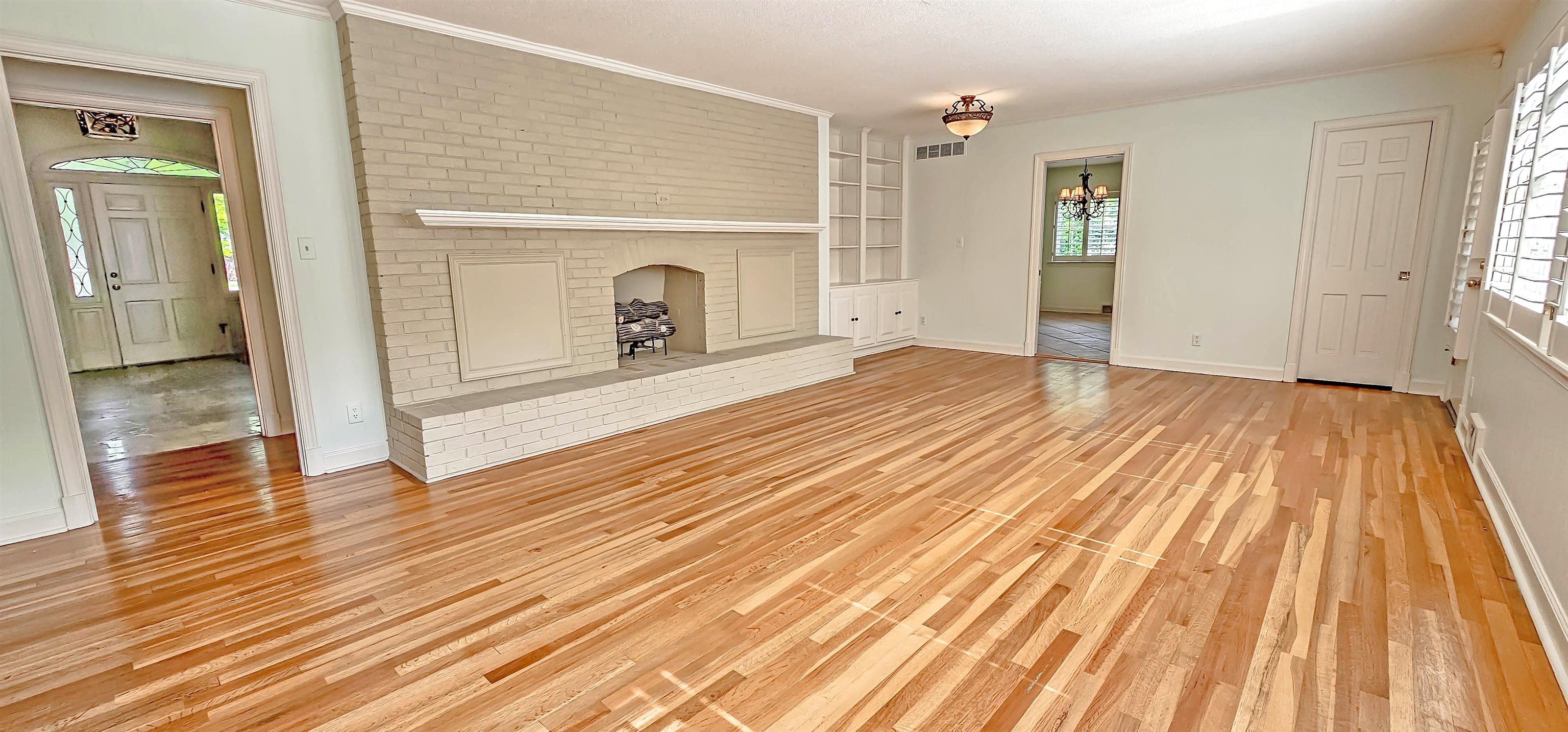 154 Perkins Extension Memphis, TN 38117 - Photo 14 of 40 a view of empty room with wooden floor and fireplace
