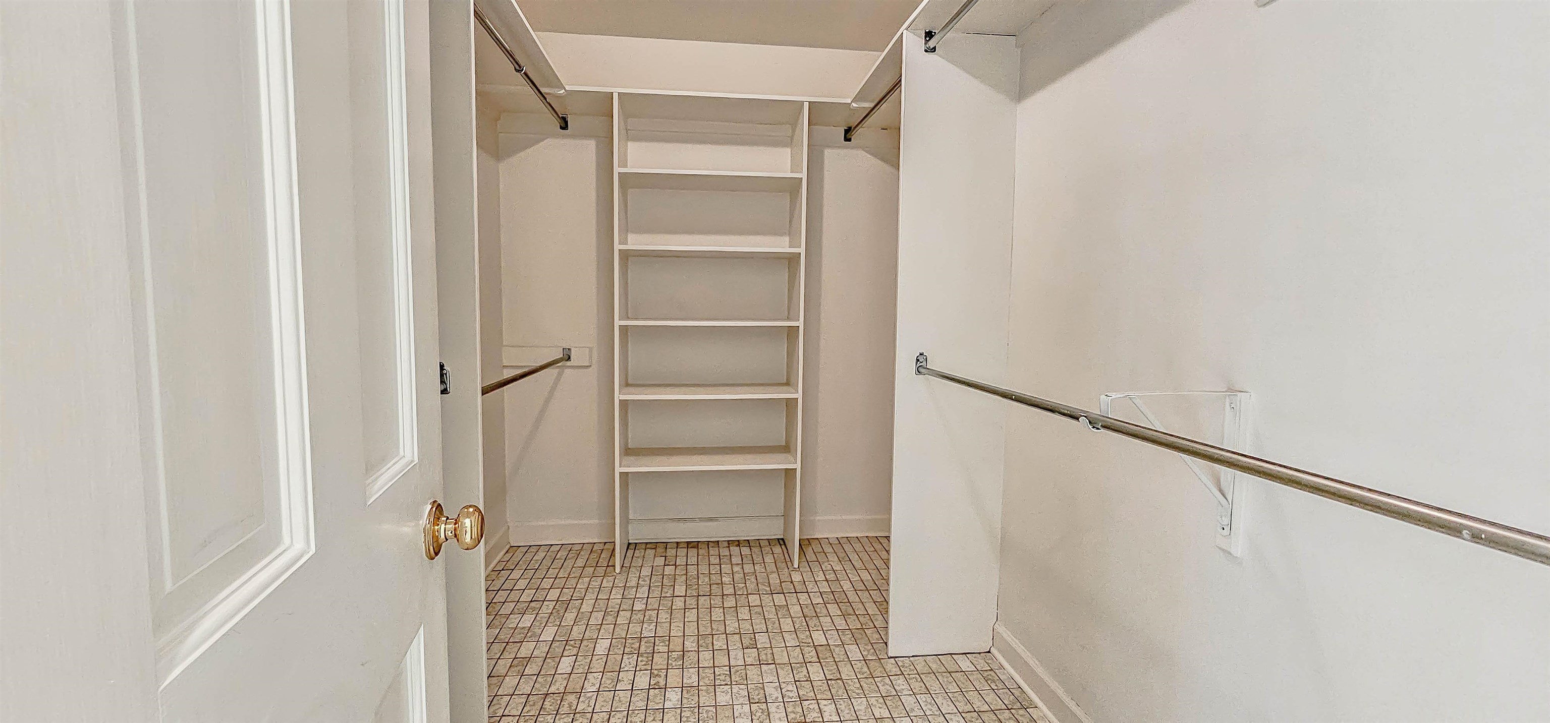 154 Perkins Extension Memphis, TN 38117 - Photo 19 of 40 a view of walk in closet with empty racks