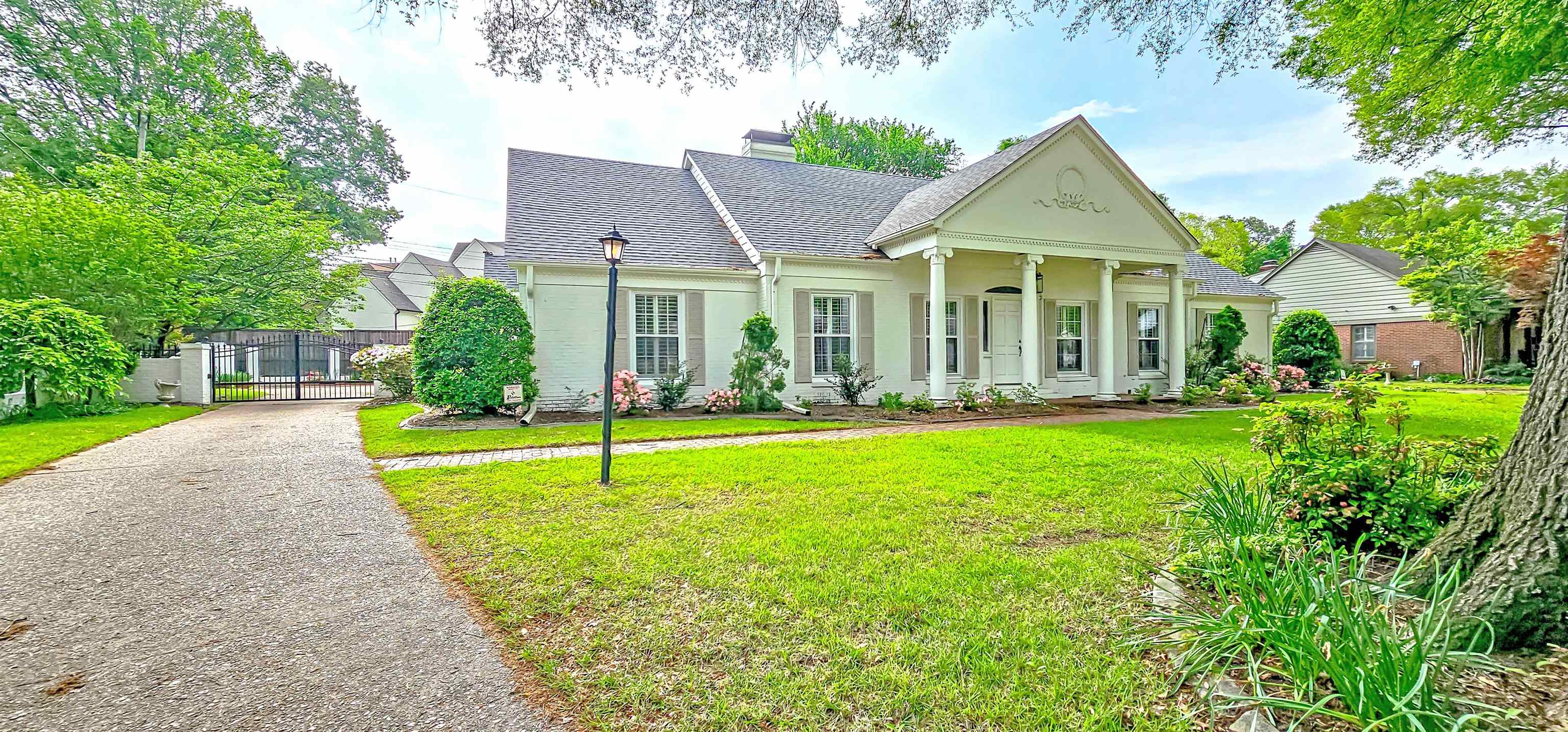 154 Perkins Extension Memphis, TN 38117 - Photo 2 of 40 a front view of a house with a yard
