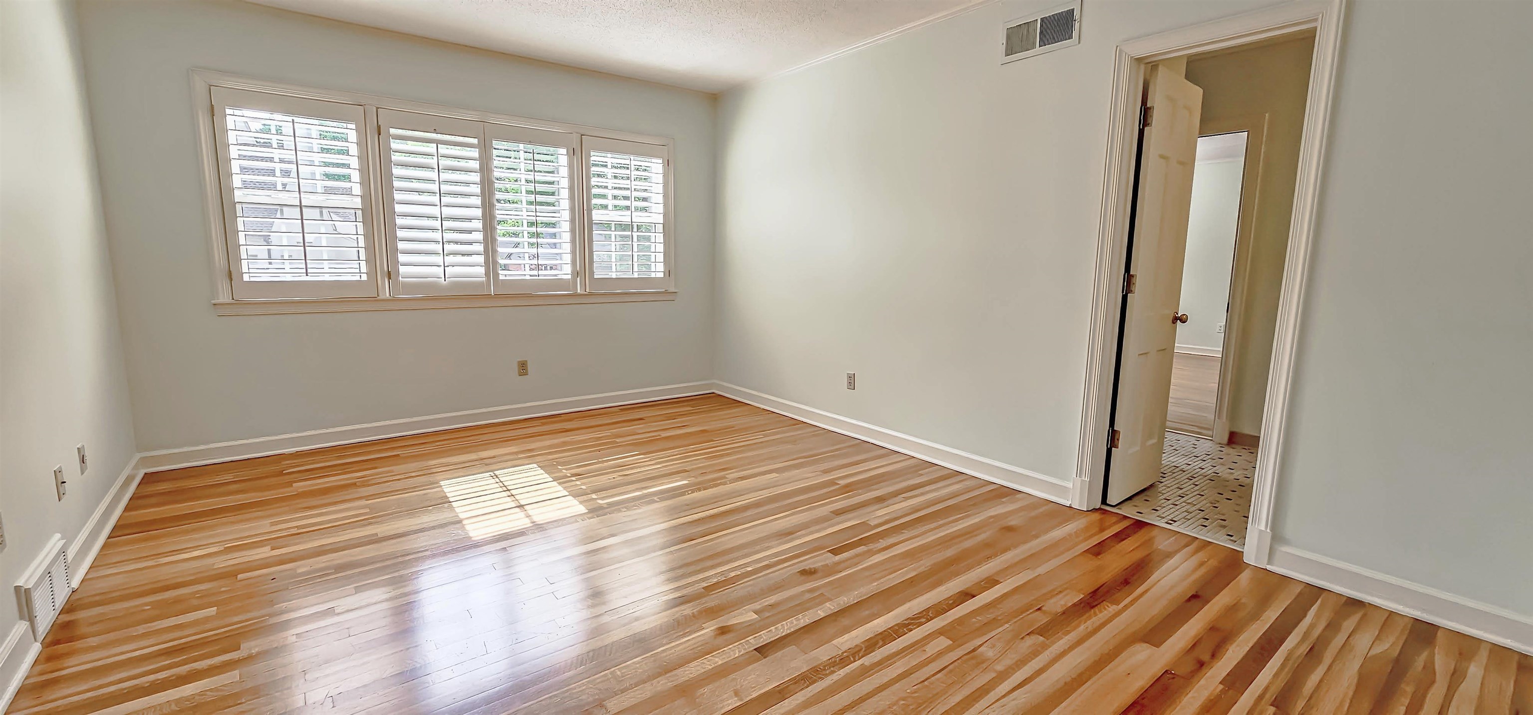 154 Perkins Extension Memphis, TN 38117 - Photo 28 of 40 a view of empty room with wooden floor and fan