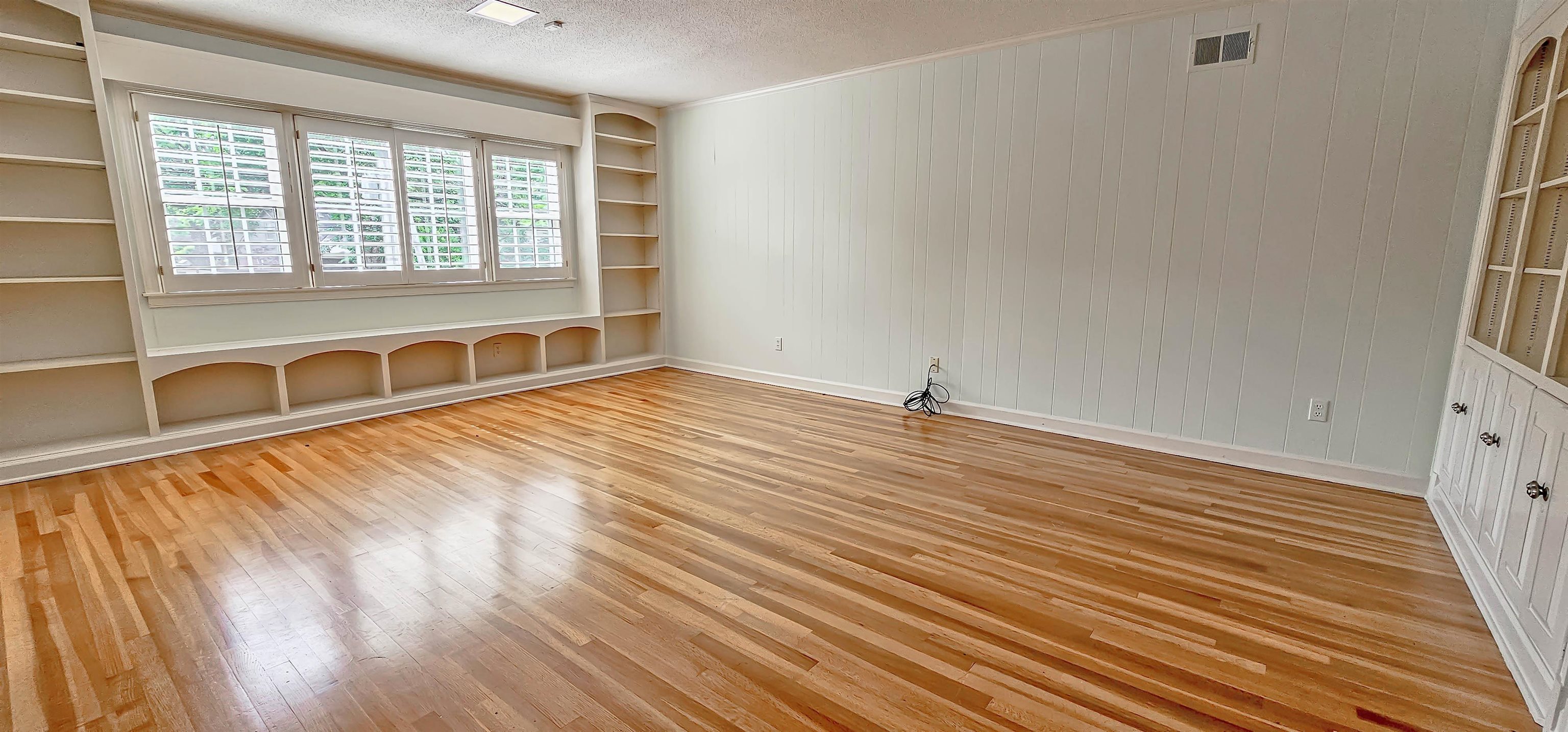 154 Perkins Extension Memphis, TN 38117 - Photo 29 of 40 a view of an empty room with wooden floor and a window