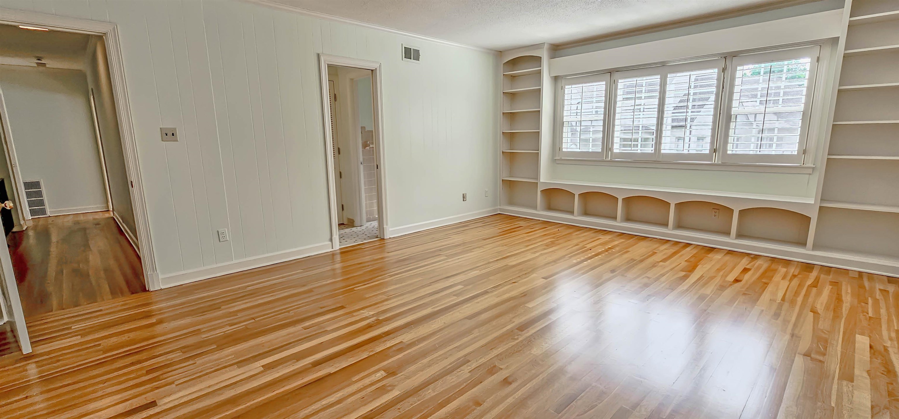 154 Perkins Extension Memphis, TN 38117 - Photo 30 of 40 an empty room with wooden floor and windows