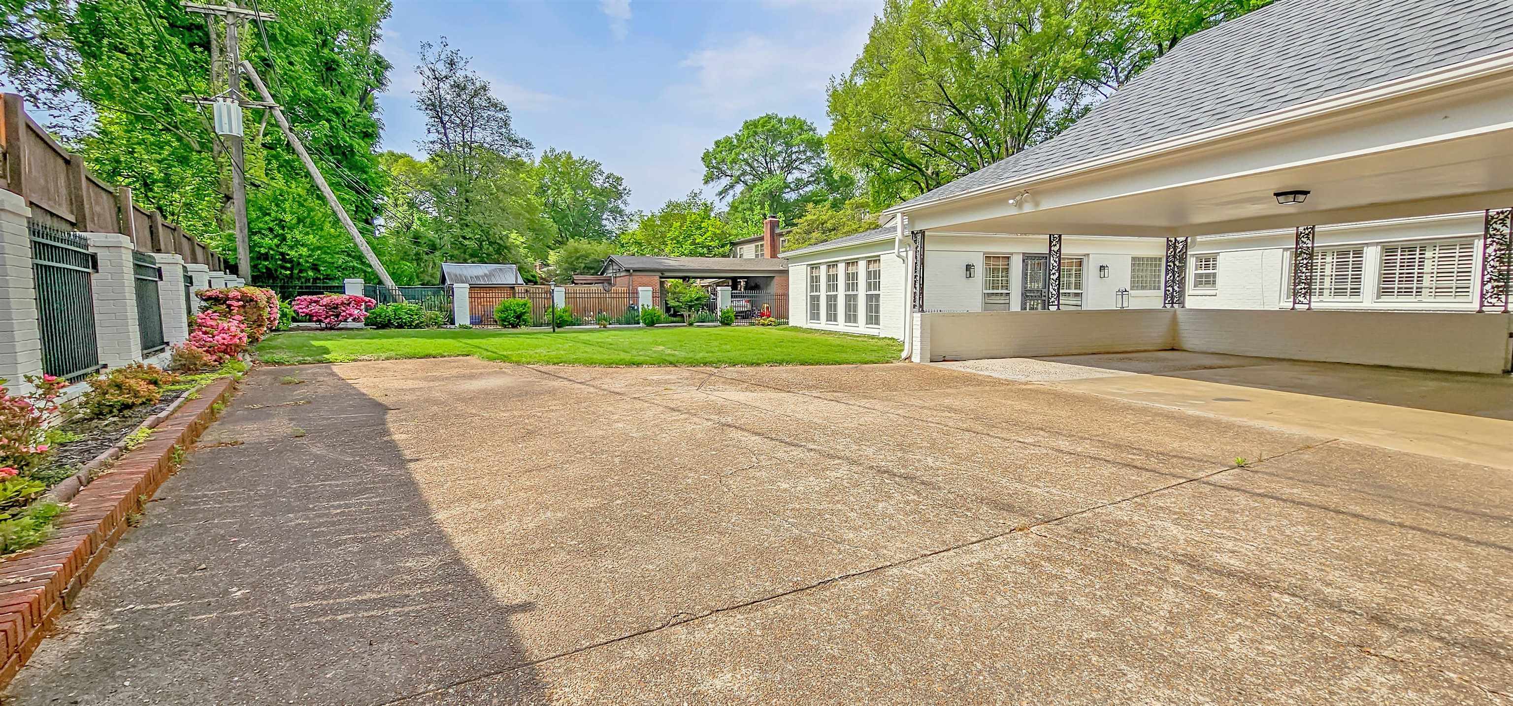 154 Perkins Extension Memphis, TN 38117 - Photo 37 of 40 a front view of a house with a yard and trees