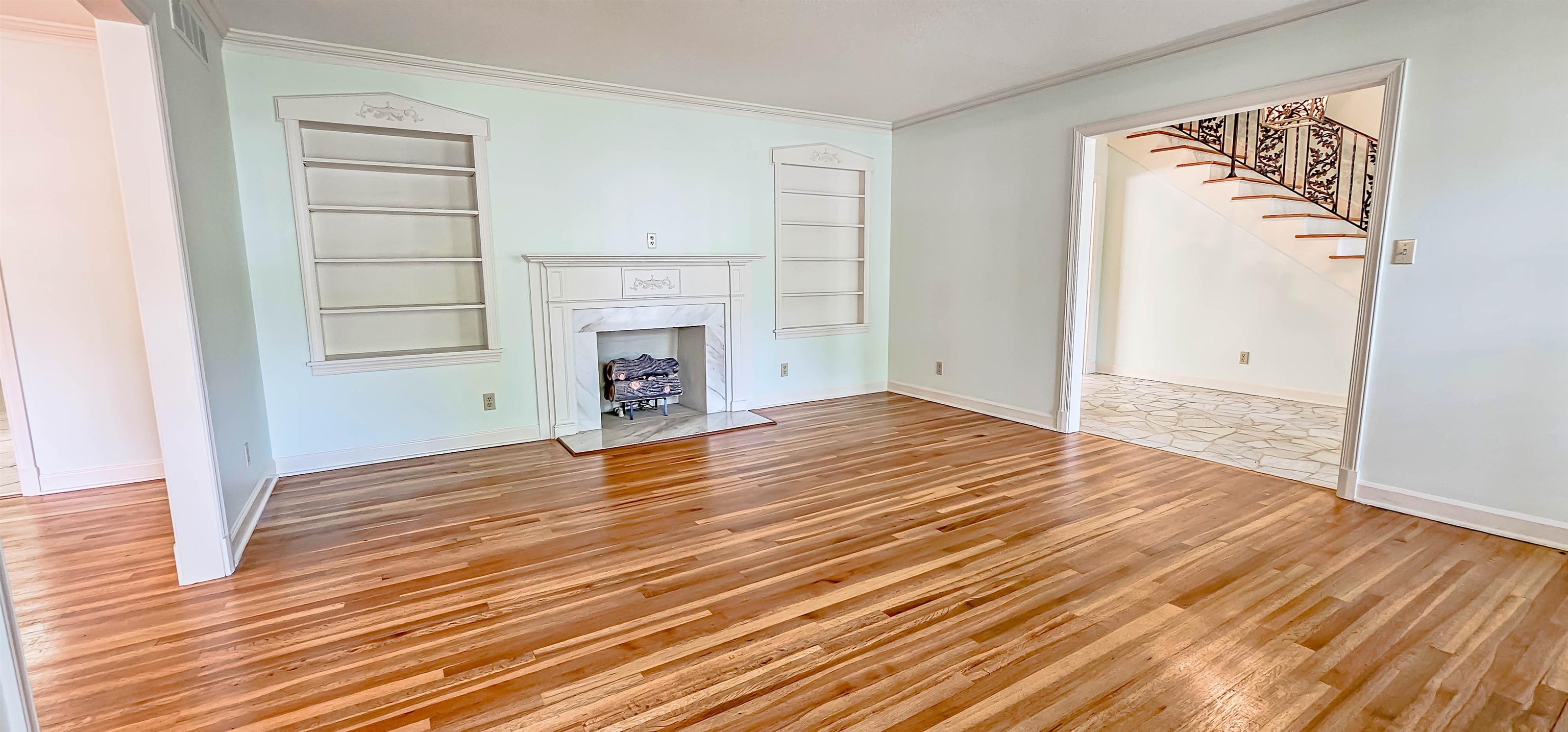 154 Perkins Extension Memphis, TN 38117 - Photo 4 of 40 an empty room with wooden floor fireplace and windows