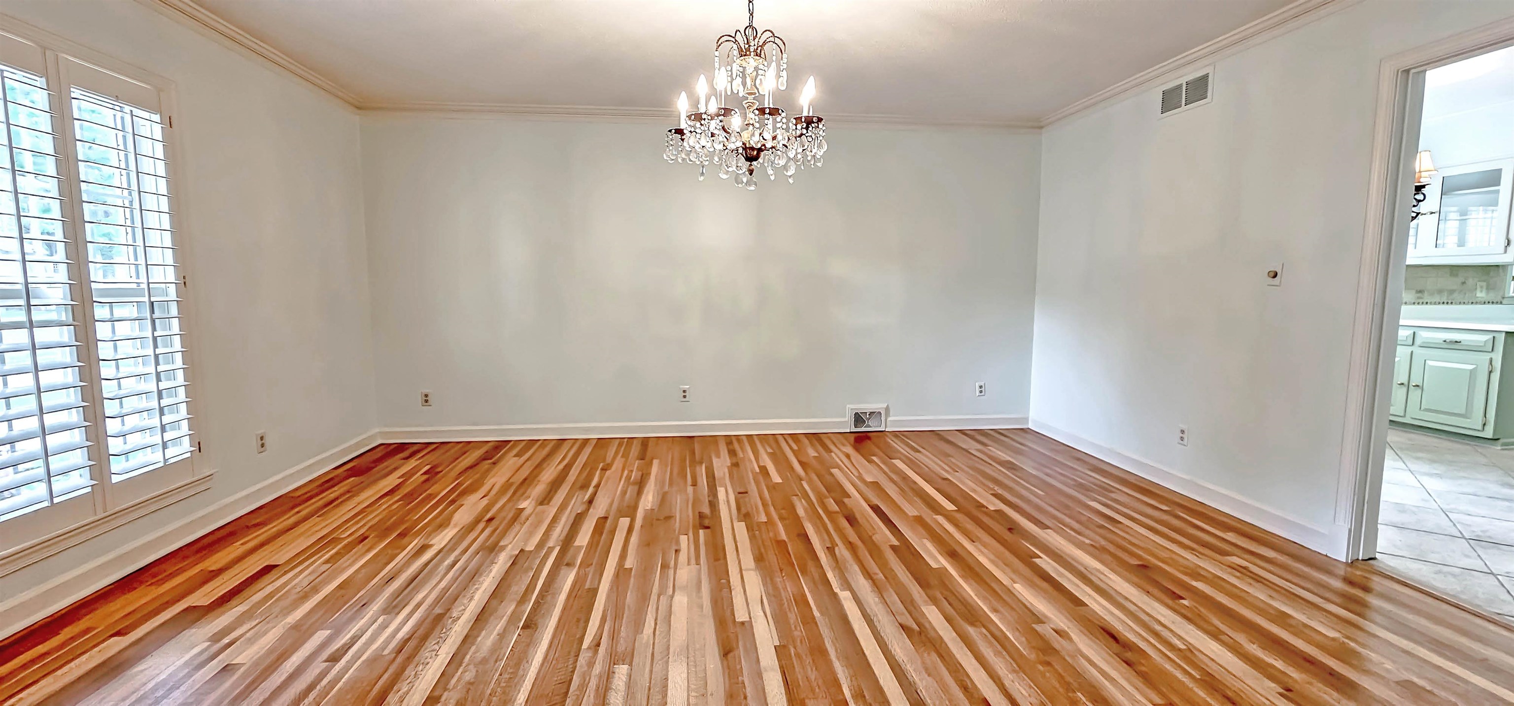 154 Perkins Extension Memphis, TN 38117 - Photo 7 of 40 a view of a room with wooden floor and chandelier