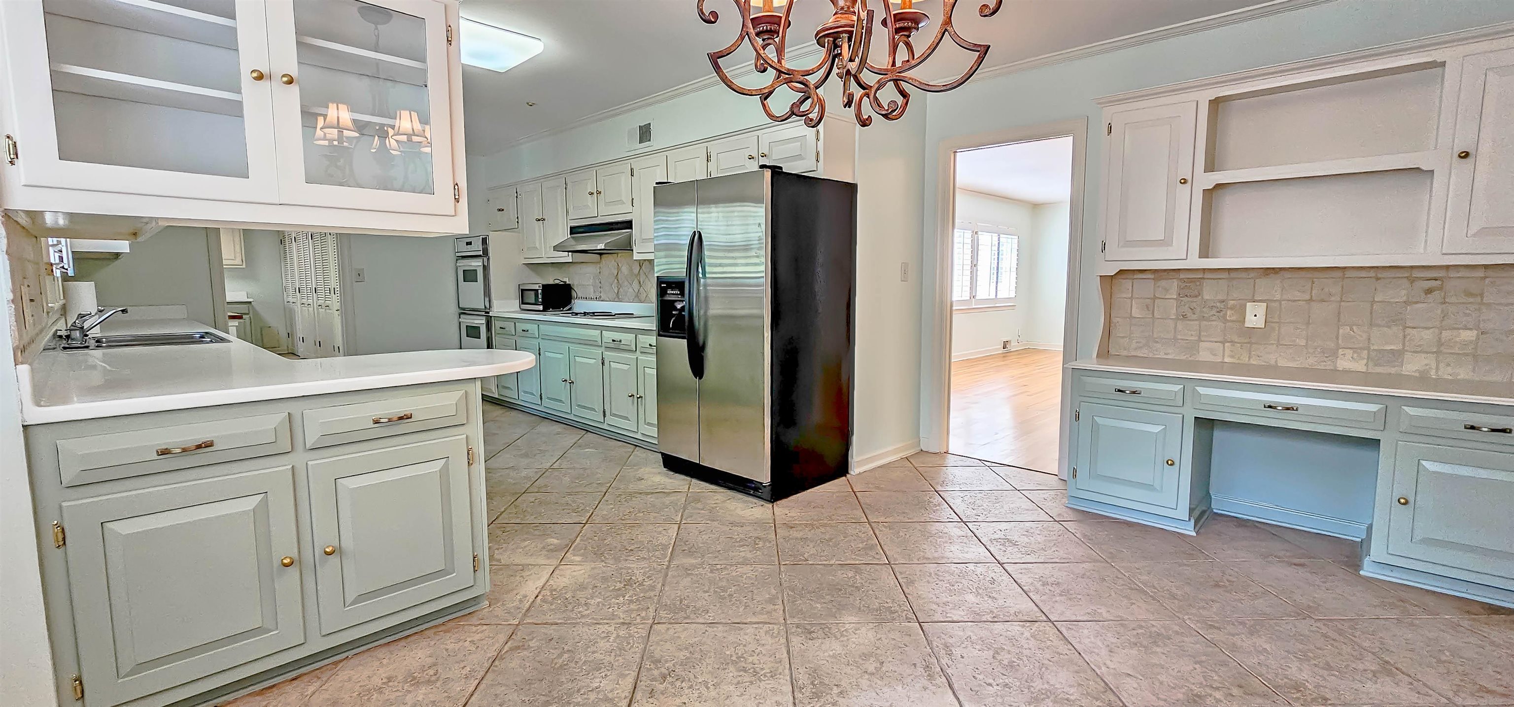 154 Perkins Extension Memphis, TN 38117 - Photo 8 of 40 a kitchen with stainless steel appliances a sink and a refrigerator