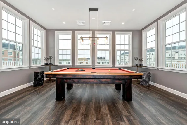 a living room with fireplace furniture and a large window