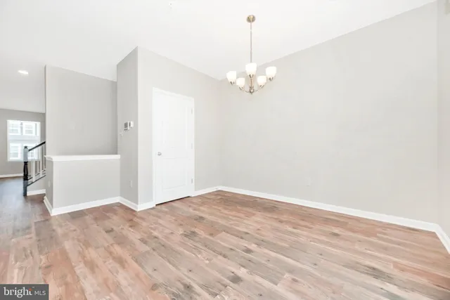 a kitchen with stainless steel appliances a stove top oven a sink and a refrigerator