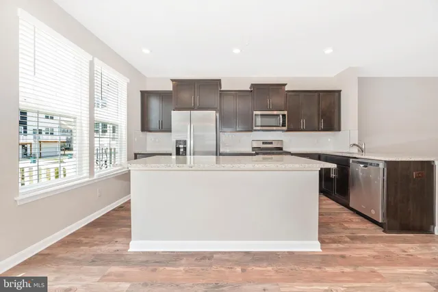 a kitchen with stainless steel appliances granite countertop a stove and a sink