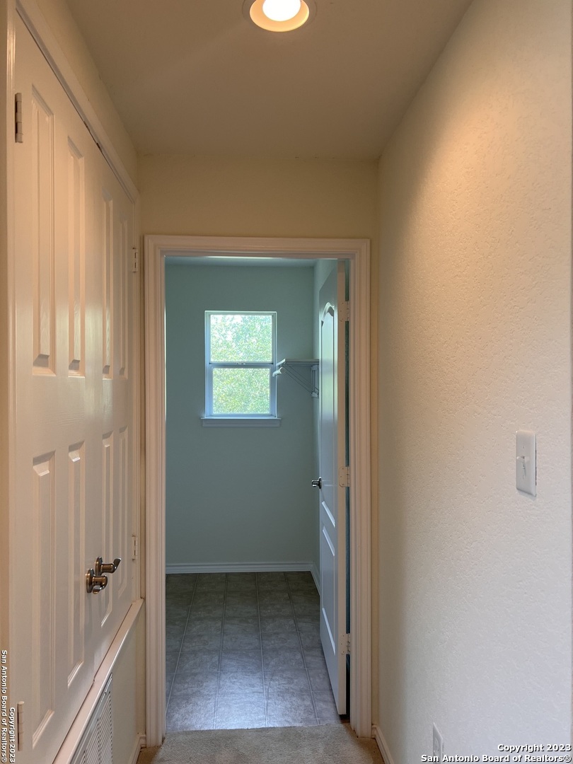 4302 Crystal Bay San Antonio, TX 78259 - Photo 14 of 32 a view of a hallway with wooden floor and a bathroom