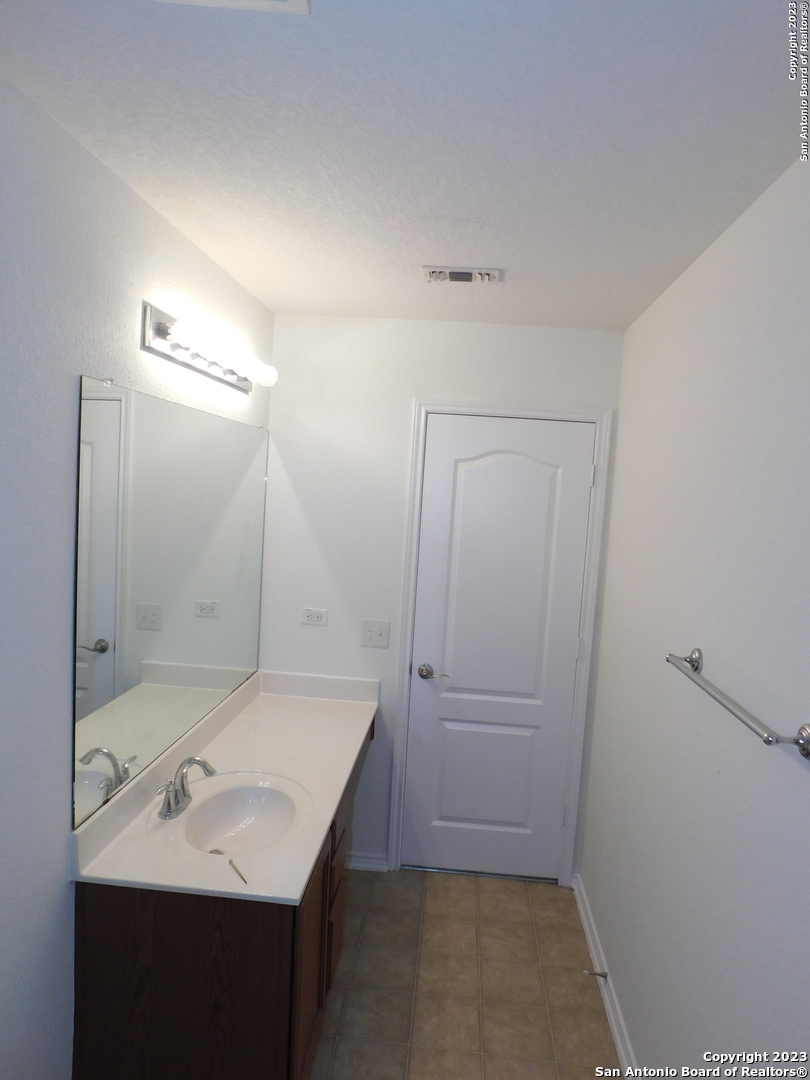 4302 Crystal Bay San Antonio, TX 78259 - Photo 23 of 32 a bathroom with a sink and a mirror