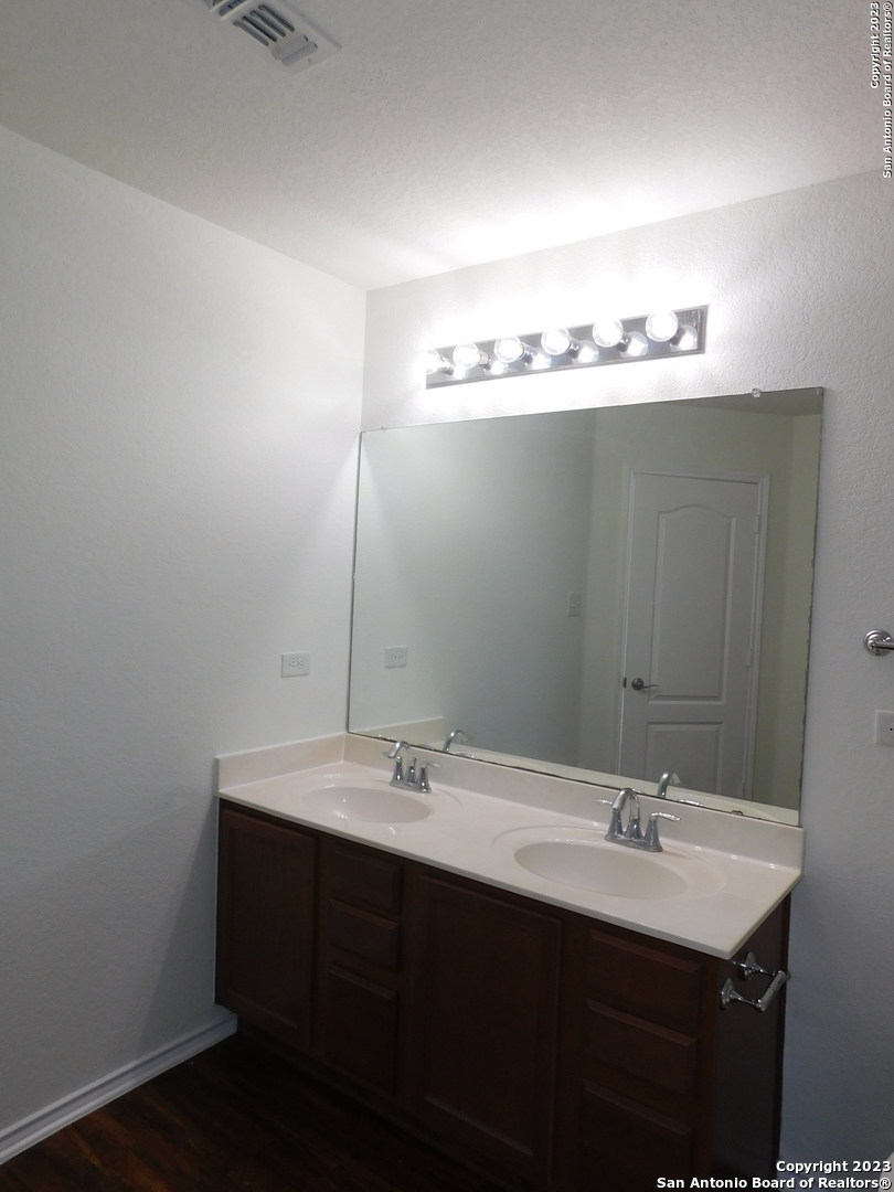 4302 Crystal Bay San Antonio, TX 78259 - Photo 28 of 32 a bathroom with a sink and a mirror