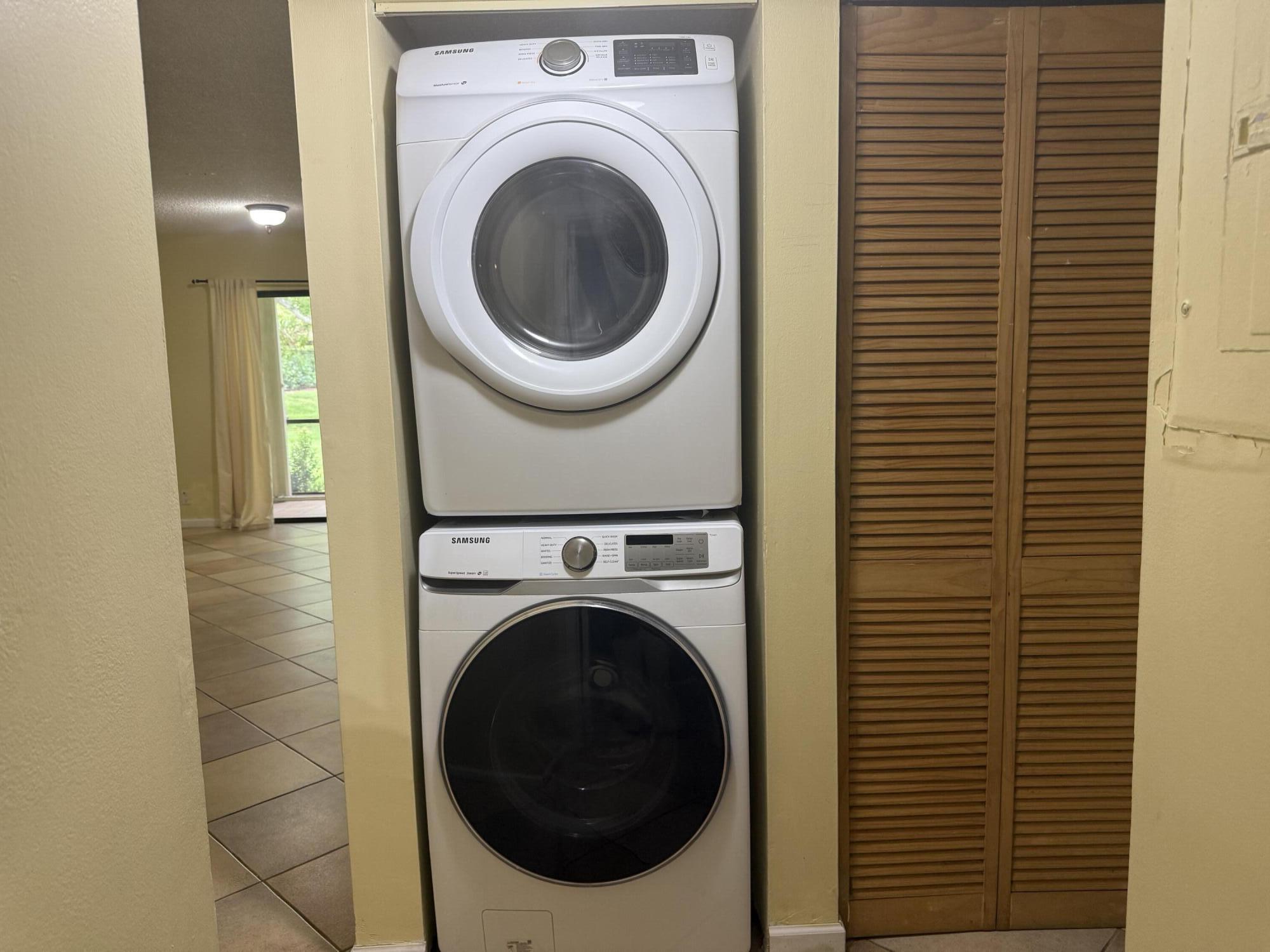 3130 Millwood Terrace, Unit 1110 Boca Raton, FL 33431 - Photo 12 of 18 a view of a hallway with washer and dryer