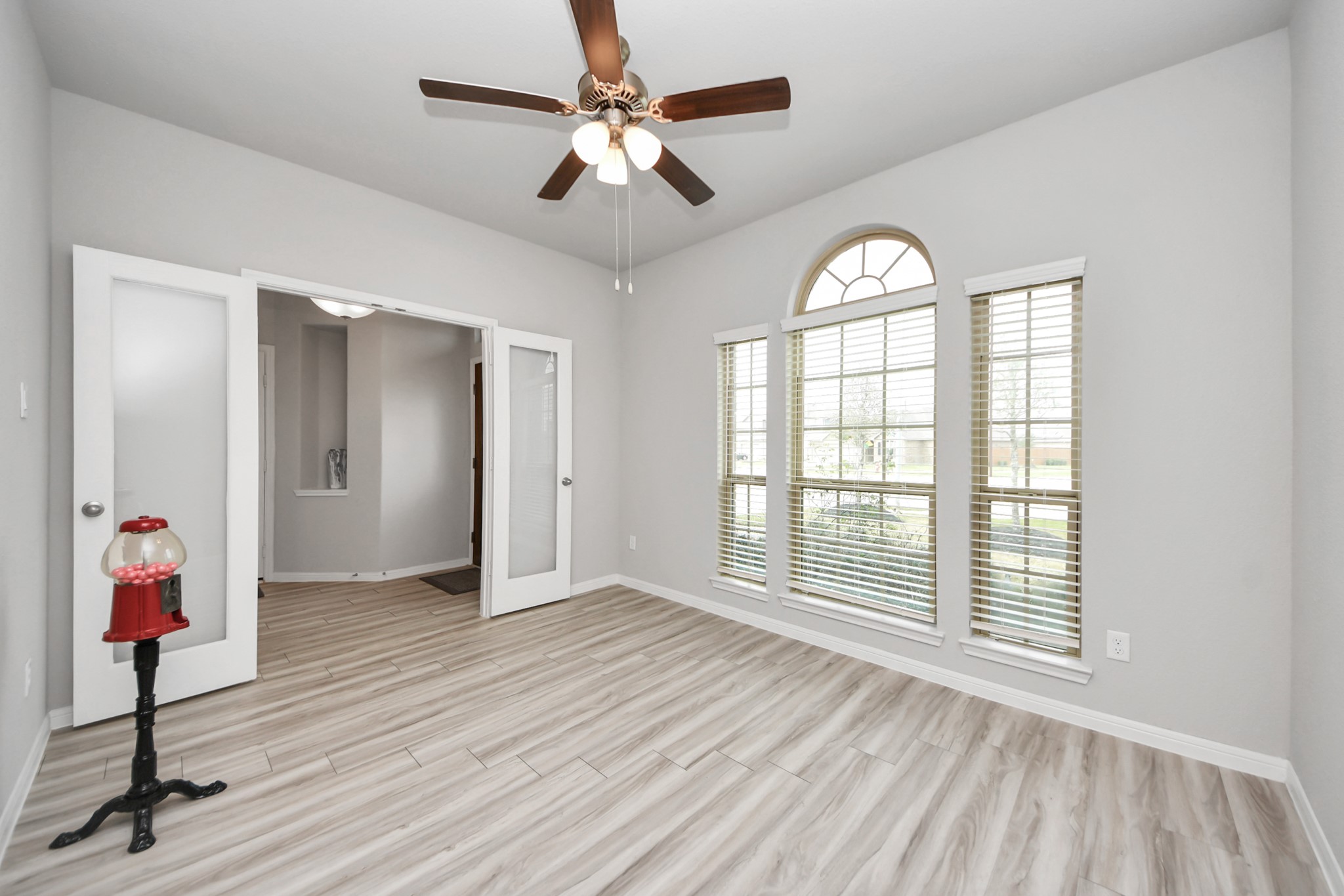 1654 Sequoia Run Drive Rosharon, TX 77583 - Photo 3 of 24 an empty room with wooden floor fan and windows