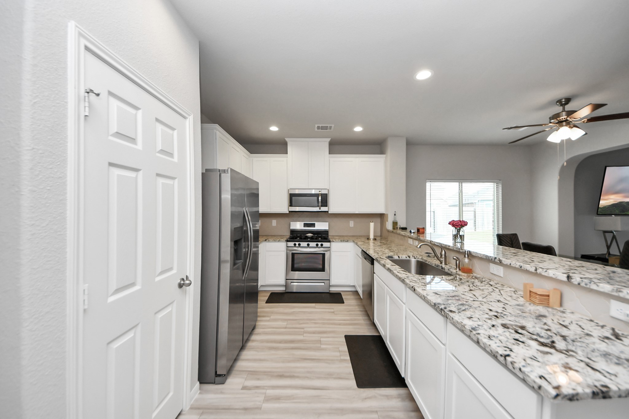 1654 Sequoia Run Drive Rosharon, TX 77583 - Photo 6 of 24 a large kitchen with stainless steel appliances granite countertop a large counter top and a stove
