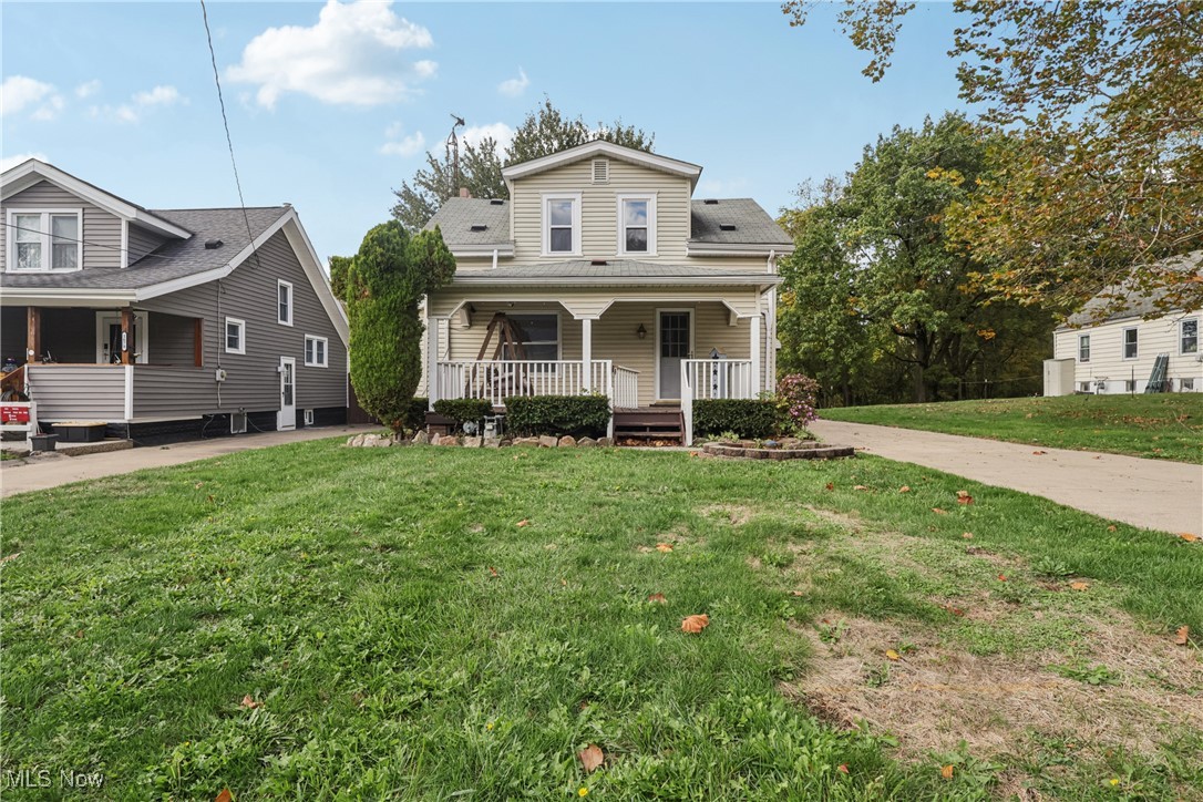 1674 Betz Road Akron, OH 44306 - Photo 22 of 29 View of front of house with a porch, a front lawn, and concrete driveway