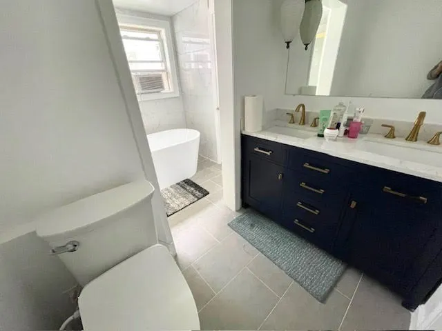 a bathroom with a toilet sink and mirror