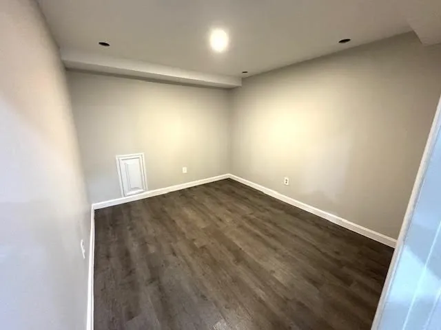 a view of a room with wooden floor