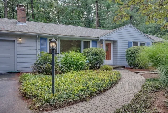 a front view of a house with a garden