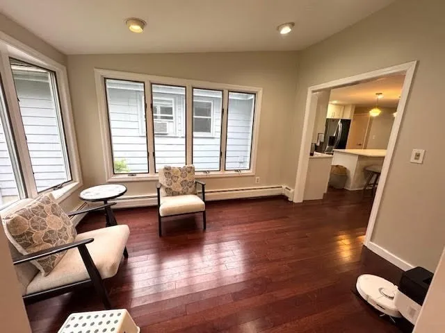 a living room with furniture and a wooden floor