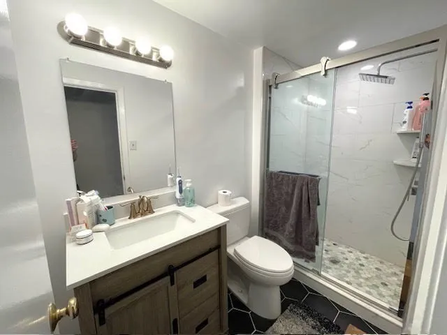 a bathroom with a sink toilet and shower