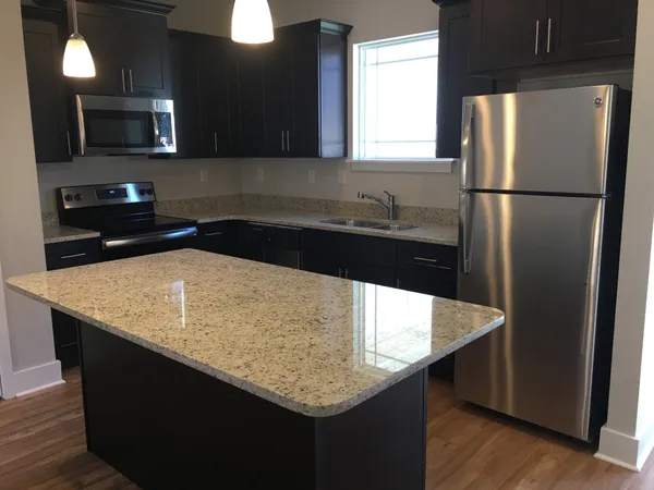 a kitchen with counter top space and stainless steel appliances
