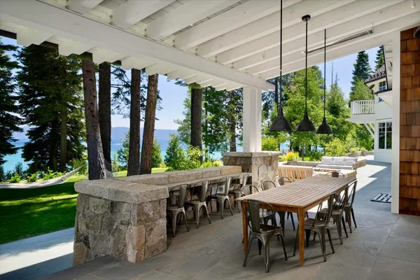 a view of an outdoor dining space with a table and chairs