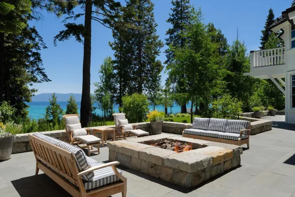 a view of a patio with couches and a fire pit