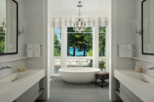 a spacious bathroom with a bathtub sink and mirror