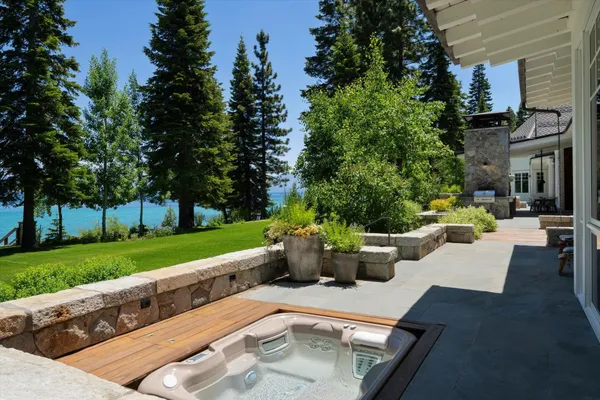 a view of a patio with couches and table and chairs and potted plants