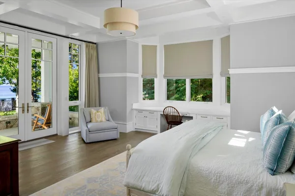 a bedroom with a large bed and a large window