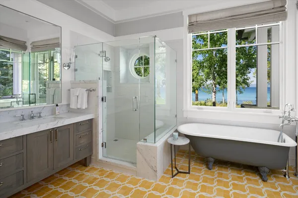 a bathroom with a bathtub sink and mirror